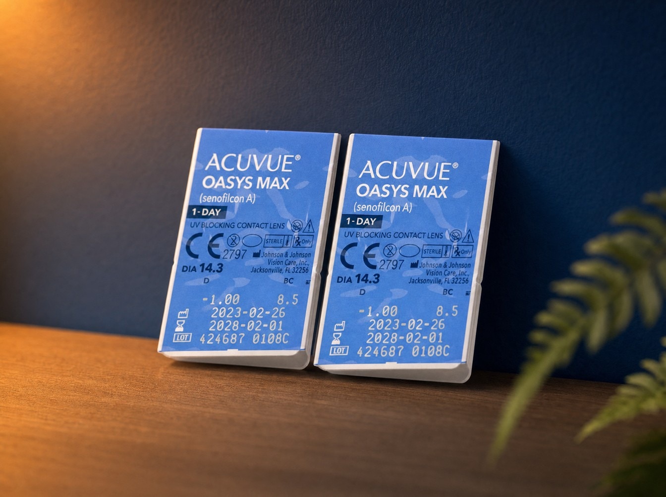 Two ACUVUE Oasys Max 1-Day contact lens trial packs standing side by side against the exam room wall